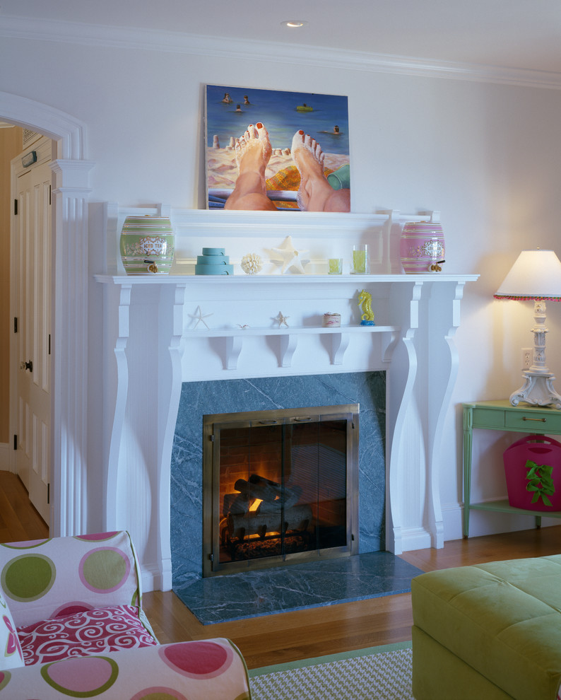 This is an example of a mid-sized beach style kids' playroom in Boston with white walls and light hardwood floors.