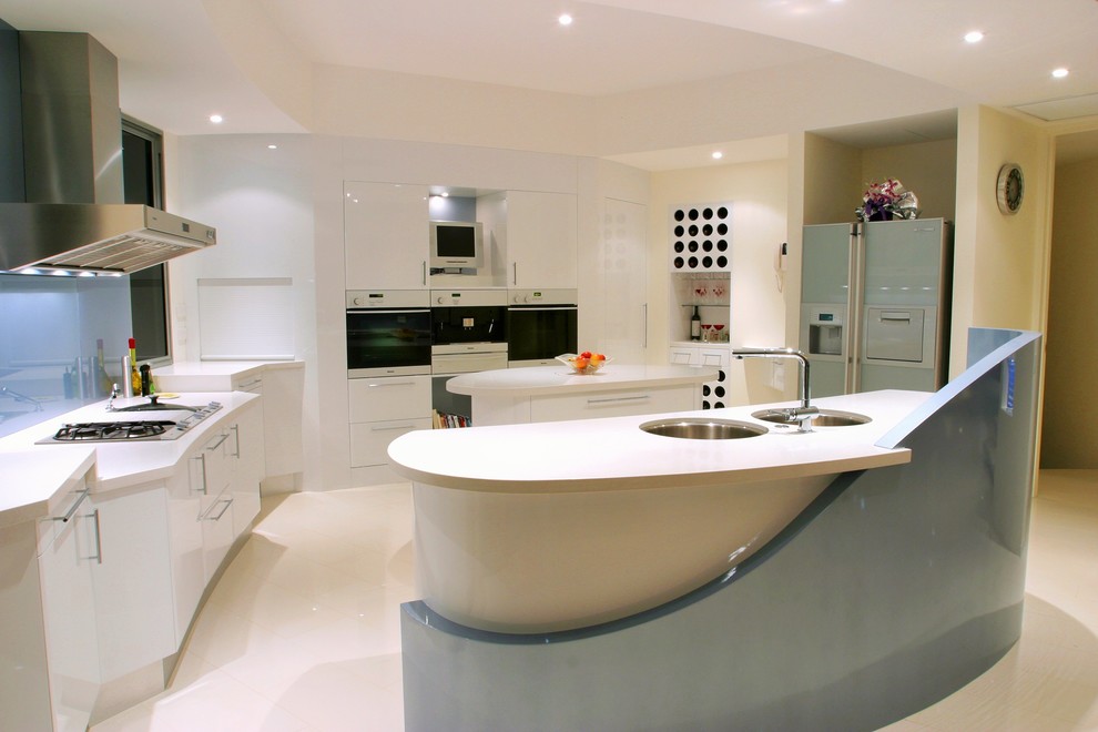 Photo of a large contemporary u-shaped open plan kitchen in Sunshine Coast with an undermount sink, flat-panel cabinets, white cabinets, quartz benchtops, blue splashback, glass sheet splashback, coloured appliances, ceramic floors and with island.