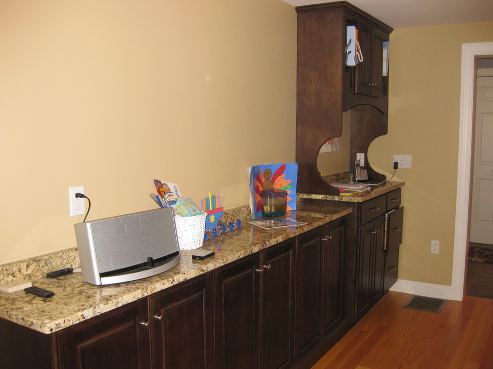 Inspiration for a transitional l-shaped light wood floor eat-in kitchen remodel in Boston with beige walls, an undermount sink, raised-panel cabinets, white cabinets, granite countertops, beige backsplash, ceramic backsplash, stainless steel appliances and an island