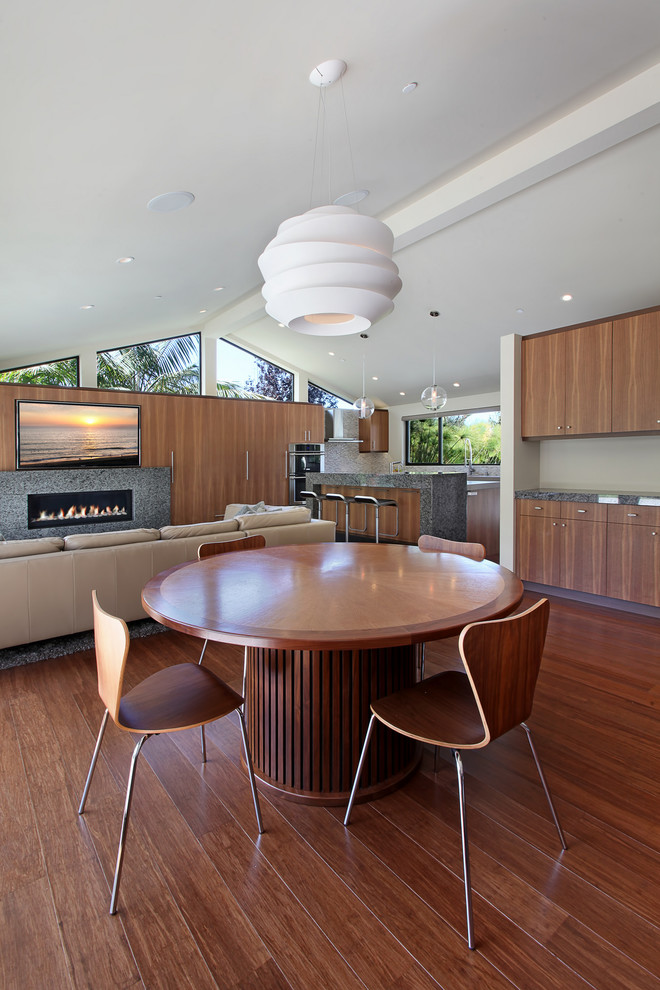 Midcentury open plan dining in Orange County with bamboo floors.
