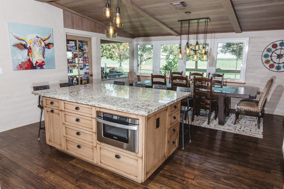 This is an example of a large country u-shaped eat-in kitchen in Boston with a farmhouse sink, granite benchtops, stainless steel appliances, dark hardwood floors, with island, shaker cabinets, light wood cabinets, brown splashback and matchstick tile splashback.