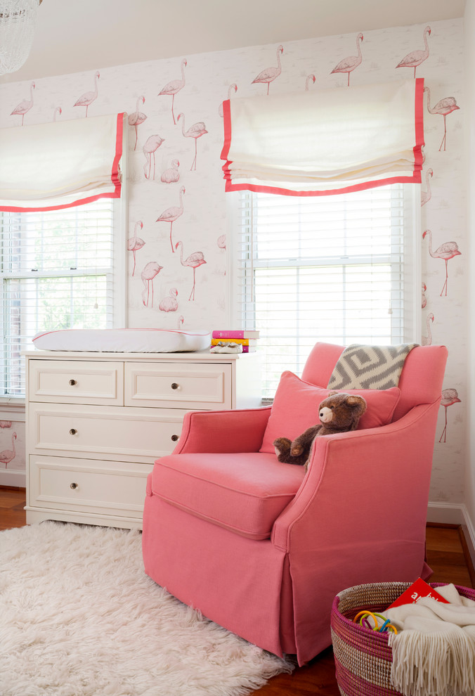 Inspiration for a mid-sized transitional nursery for girls in New York with multi-coloured walls and medium hardwood floors.