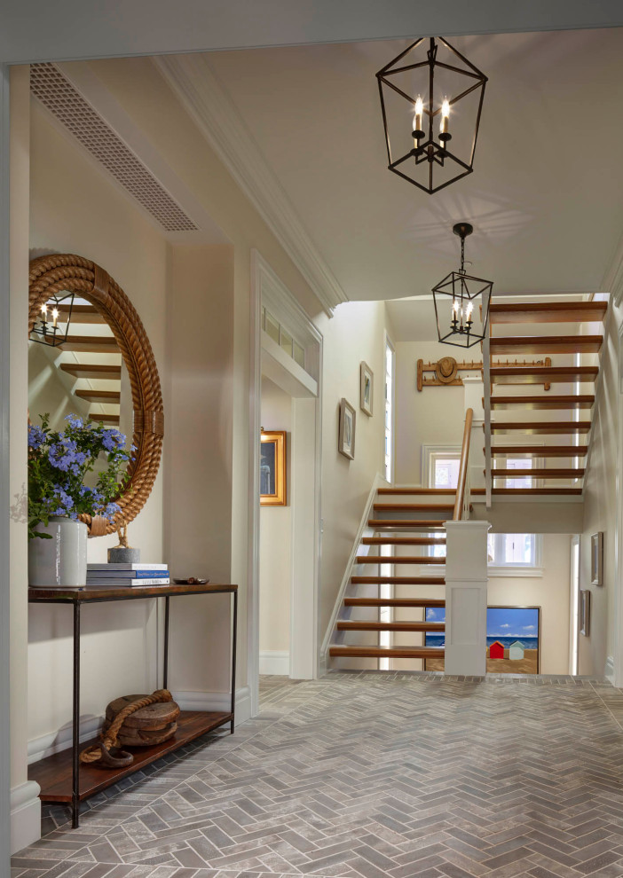 Photo of a medium sized rural foyer in Baltimore with beige walls, a single front door and grey floors.