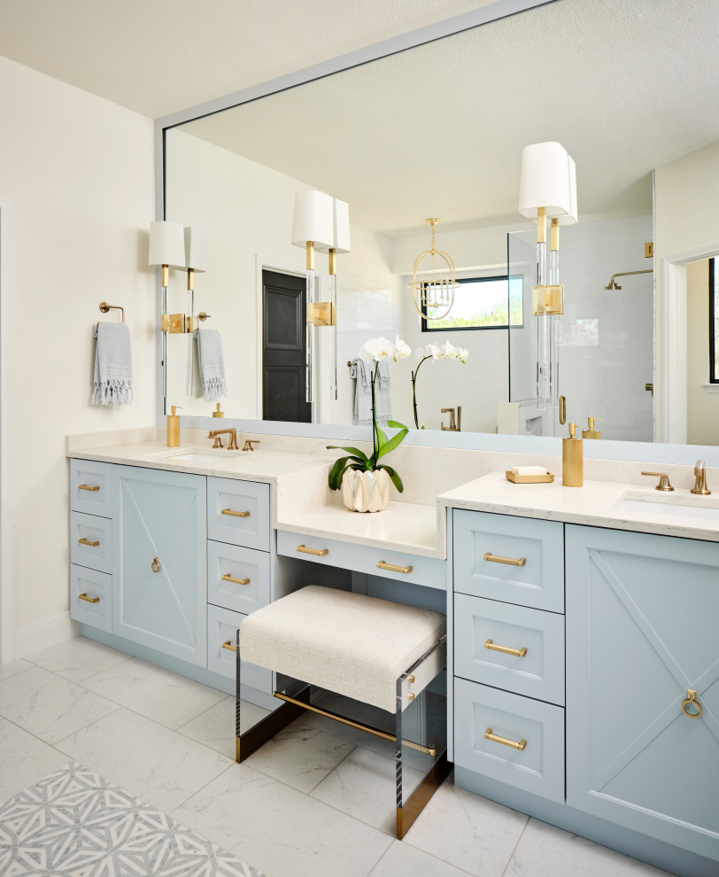 Photo of a mid-sized transitional master bathroom in Austin with furniture-like cabinets, blue cabinets, a freestanding tub, an open shower, a bidet, white tile, subway tile, white walls, marble floors, an undermount sink, engineered quartz benchtops, multi-coloured floor, a hinged shower door, white benchtops, an enclosed toilet, a double vanity and a built-in vanity.