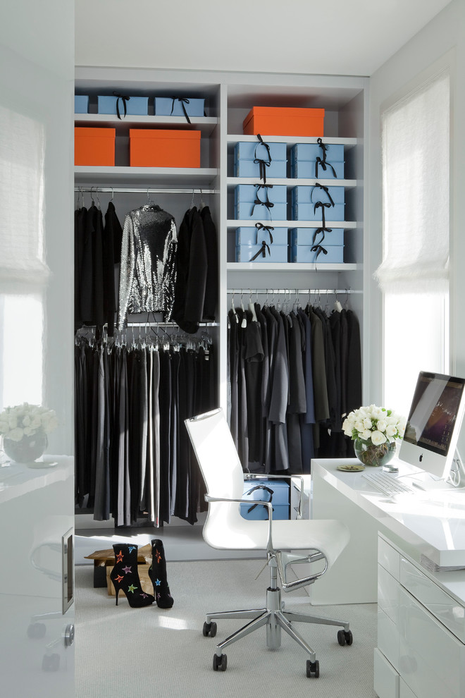 This is an example of a contemporary women's dressing room in New York with open cabinets and white cabinets.
