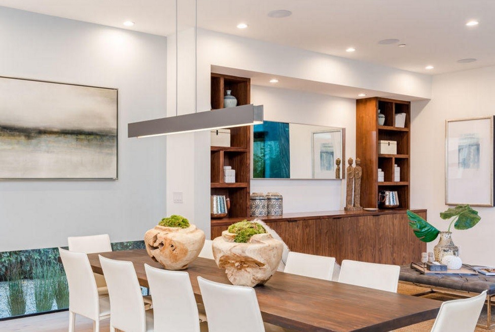 This is an example of a mid-sized contemporary open plan dining in Los Angeles with white walls, light hardwood floors and no fireplace.