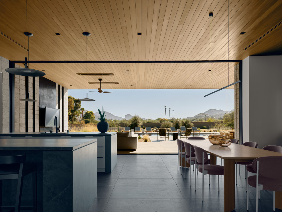 Inspiration for a modern single-wall porcelain tile, gray floor and wood ceiling open concept kitchen remodel in Phoenix with an undermount sink, flat-panel cabinets, quartz countertops, gray backsplash, quartz backsplash, paneled appliances, two islands and gray countertops