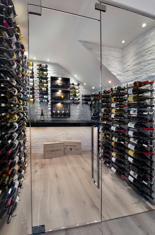 This is an example of a contemporary wine cellar in Miami with storage racks and beige floor.