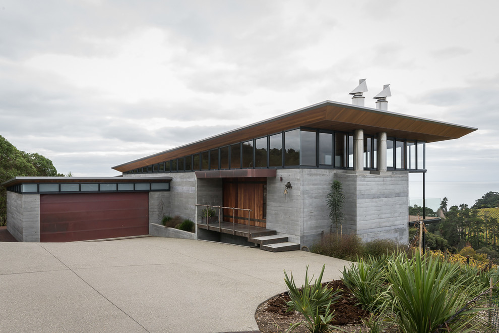 Inspiration for a contemporary two-storey concrete grey house exterior in Auckland with a shed roof.