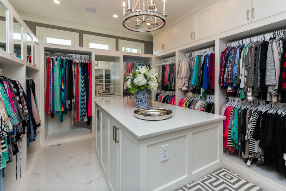 This is an example of a large traditional gender-neutral walk-in wardrobe in Other with recessed-panel cabinets and white cabinets.