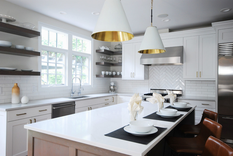 Inspiration for a large transitional l-shaped open plan kitchen in Philadelphia with an undermount sink, shaker cabinets, white cabinets, quartz benchtops, yellow splashback, subway tile splashback, stainless steel appliances, painted wood floors and white benchtop.