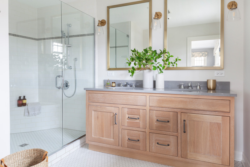 Inspiration for a mid-sized transitional master white tile ceramic tile, white floor and double-sink alcove shower remodel in Chicago with shaker cabinets, light wood cabinets, a two-piece toilet, gray walls, a drop-in sink, quartz countertops, a hinged shower door, gray countertops and a freestanding vanity