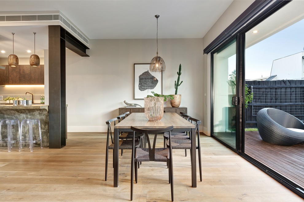 Design ideas for a contemporary open plan dining in Melbourne with grey walls and light hardwood floors.