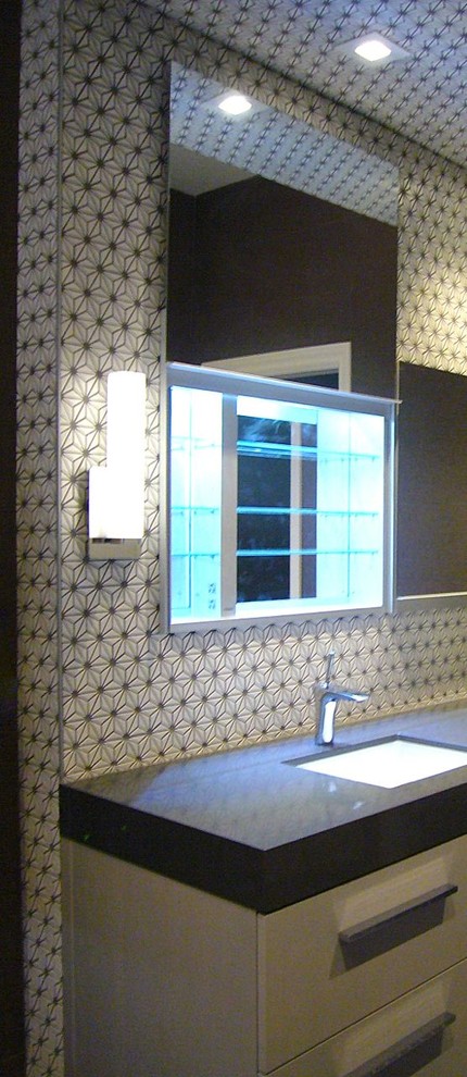 Photo of a mid-sized contemporary master bathroom in San Francisco with flat-panel cabinets, white cabinets, an undermount tub, a corner shower, a one-piece toilet, black and white tile, ceramic tile, black walls, ceramic floors, an undermount sink and engineered quartz benchtops.