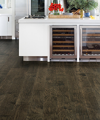 Large transitional u-shaped medium tone wood floor and brown floor open concept kitchen photo with flat-panel cabinets, white cabinets, laminate countertops, white backsplash, stainless steel appliances and an island