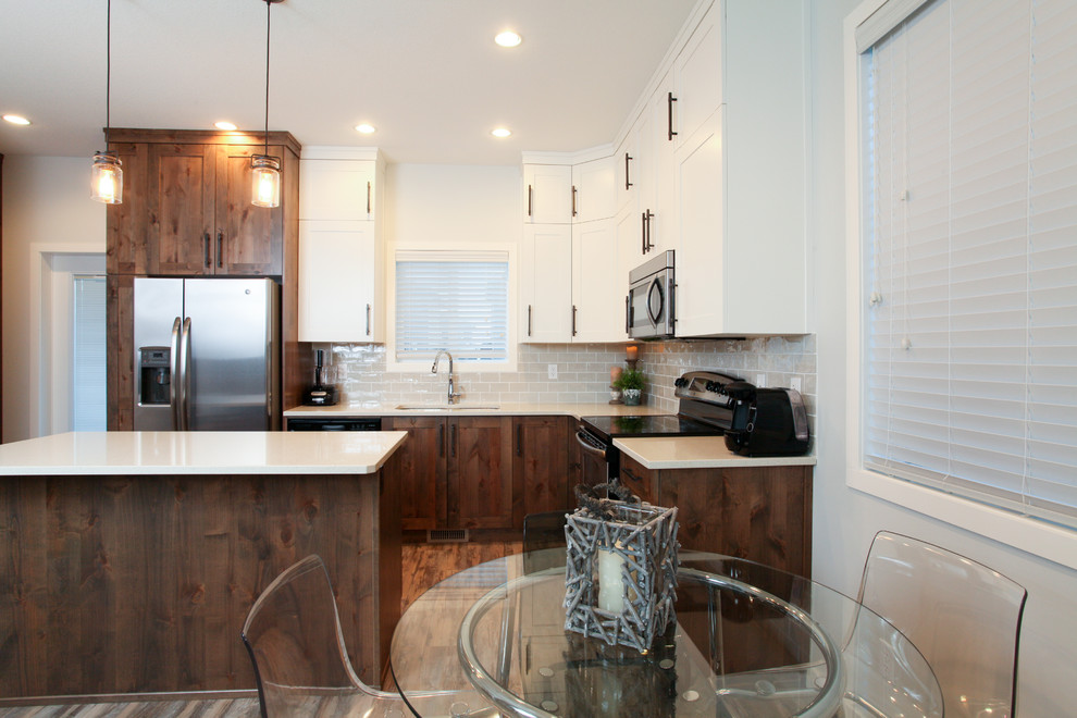 Large transitional l-shaped medium tone wood floor eat-in kitchen photo in Calgary with an undermount sink, shaker cabinets, dark wood cabinets, quartz countertops, gray backsplash, subway tile backsplash, stainless steel appliances and an island