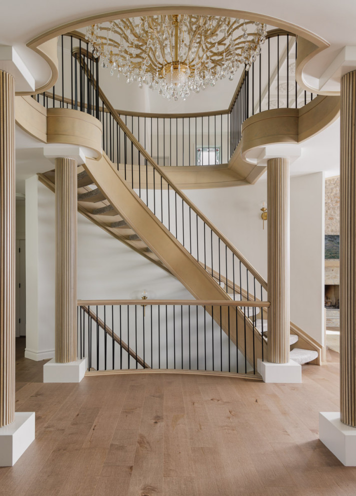 Inspiration for a large transitional carpeted curved staircase in Calgary with open risers and mixed railing.