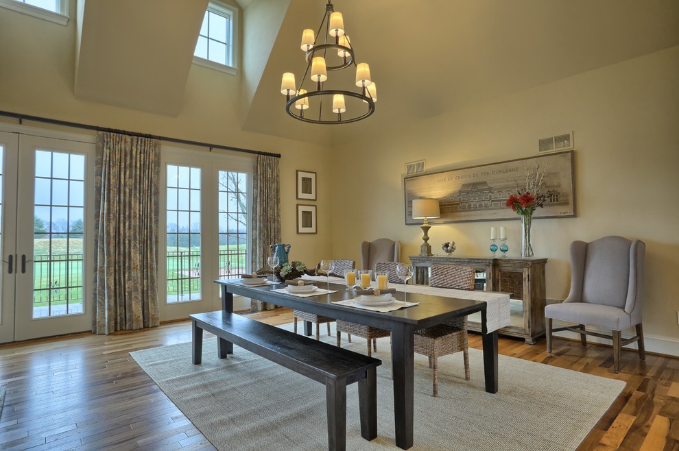 Photo of a transitional dining room in Other with yellow walls, medium hardwood floors and no fireplace.
