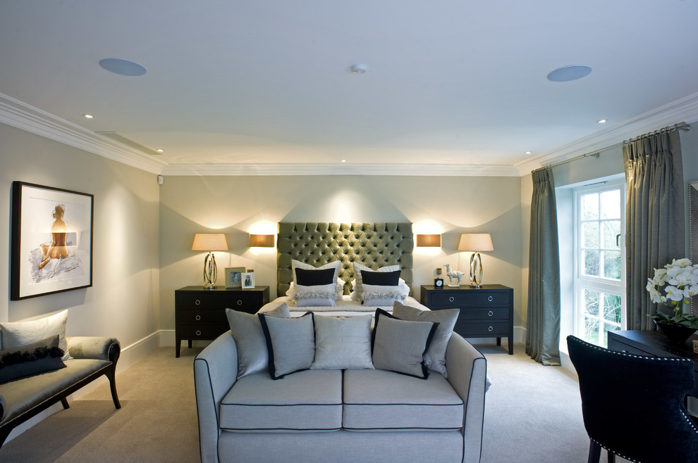 Photo of a transitional bedroom in London with grey walls and carpet.