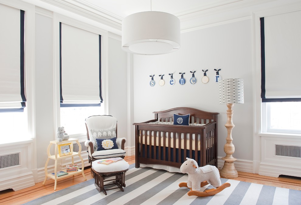 Design ideas for a mid-sized transitional nursery for boys in Miami with grey walls and medium hardwood floors.