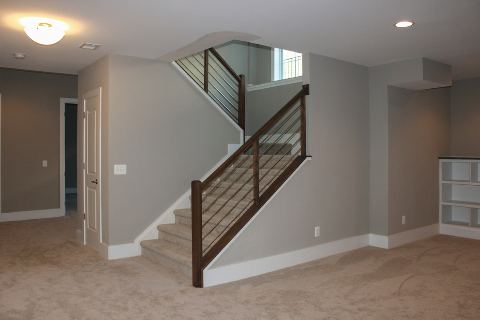 Large contemporary wood u-shaped staircase in DC Metro with mixed railing.