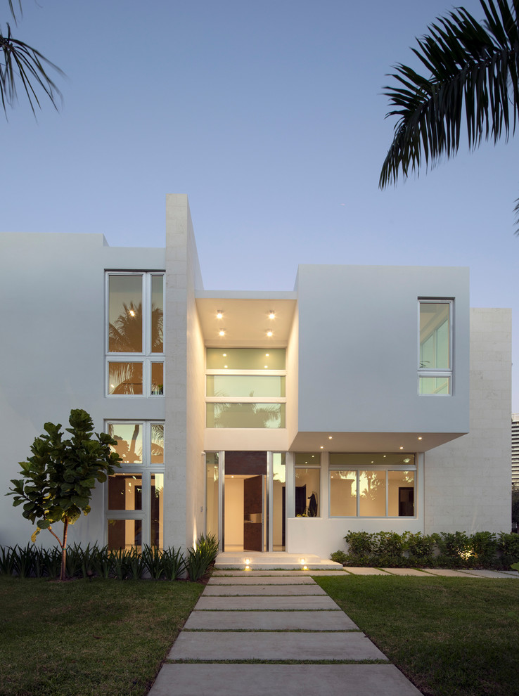 This is an example of a beach style white exterior in Miami.