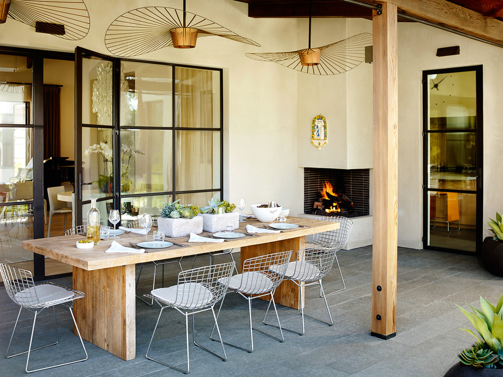 Inspiration for a contemporary backyard patio in San Francisco with a roof extension and with fireplace.