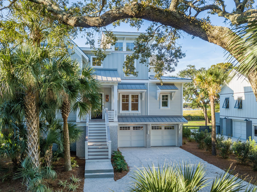 Beach style two-storey grey house exterior in Charleston with mixed siding and a hip roof.