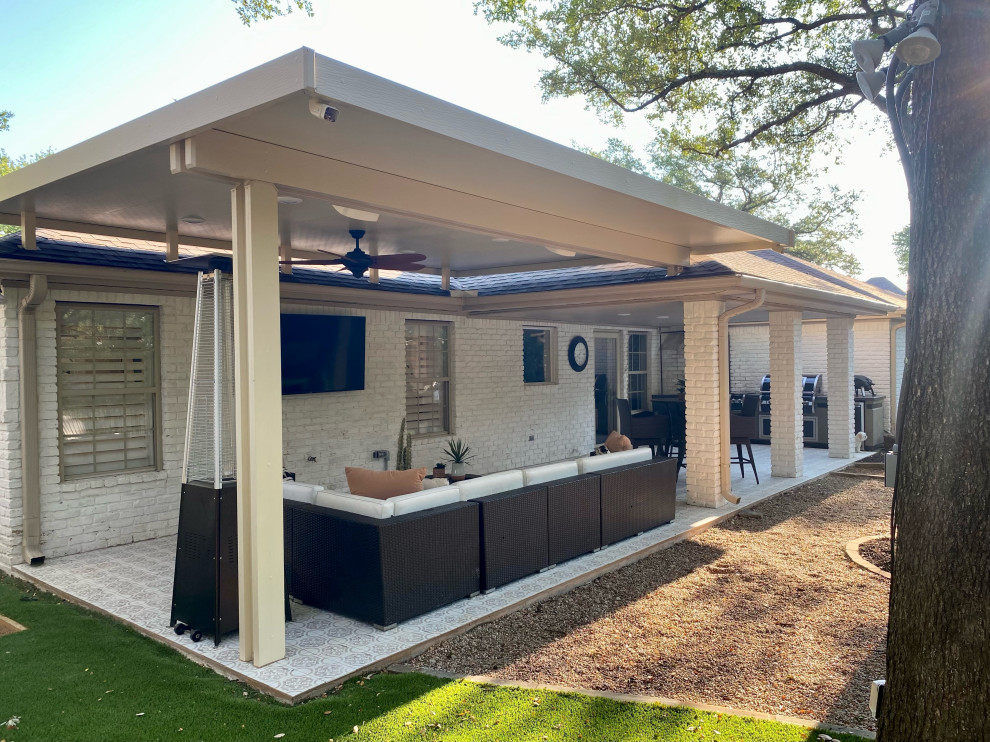 Contemporary backyard patio in Austin with tile and an awning.