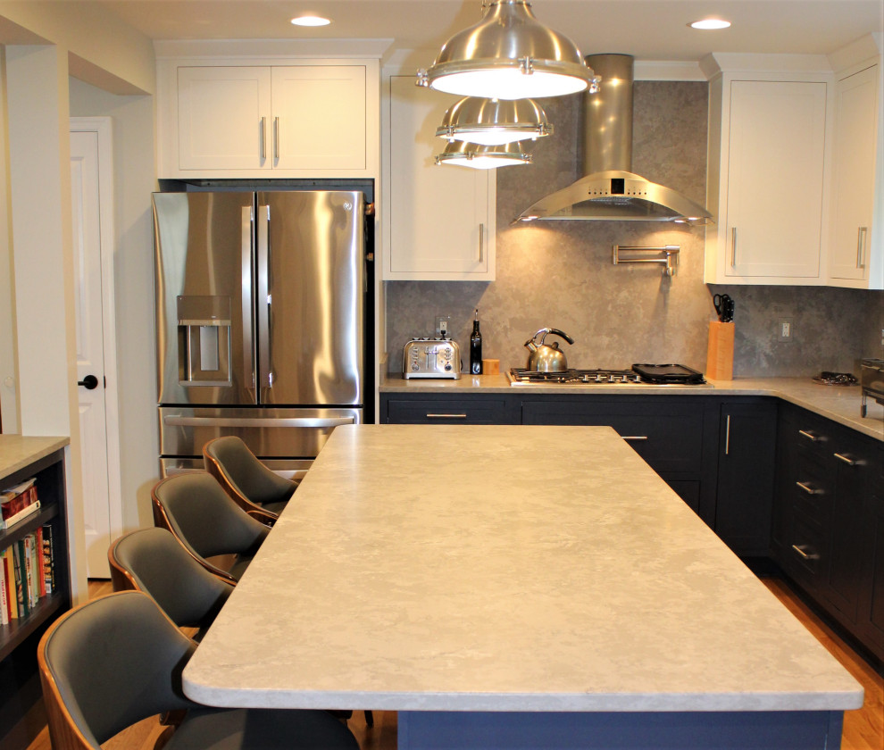 Inspiration for a large transitional u-shaped light wood floor kitchen pantry remodel in DC Metro with recessed-panel cabinets, blue cabinets, granite countertops, gray backsplash, ceramic backsplash, stainless steel appliances and an island