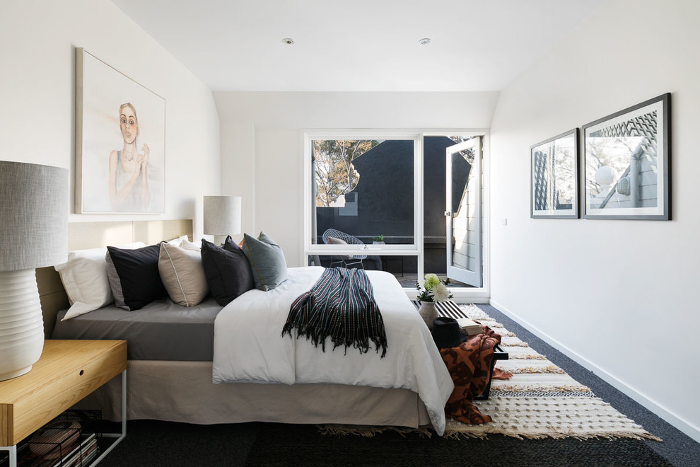 Contemporary bedroom in Melbourne with white walls, carpet and black floor.