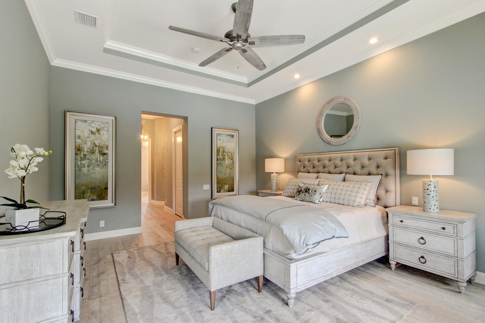Inspiration for a large transitional master bedroom in Orlando with green walls, light hardwood floors and no fireplace.