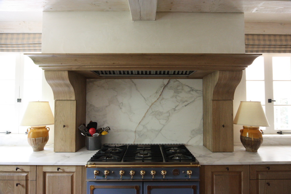 This is an example of a transitional kitchen in Atlanta with marble benchtops and marble splashback.