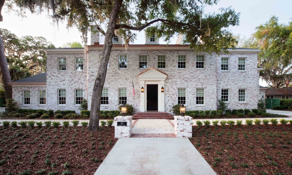 Photo of a large traditional two-storey brick white exterior in Orlando.