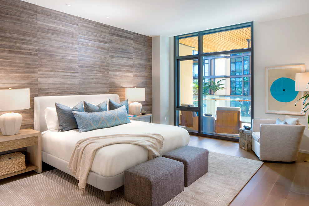 This is an example of a contemporary bedroom in Hawaii with grey walls, medium hardwood floors and brown floor.