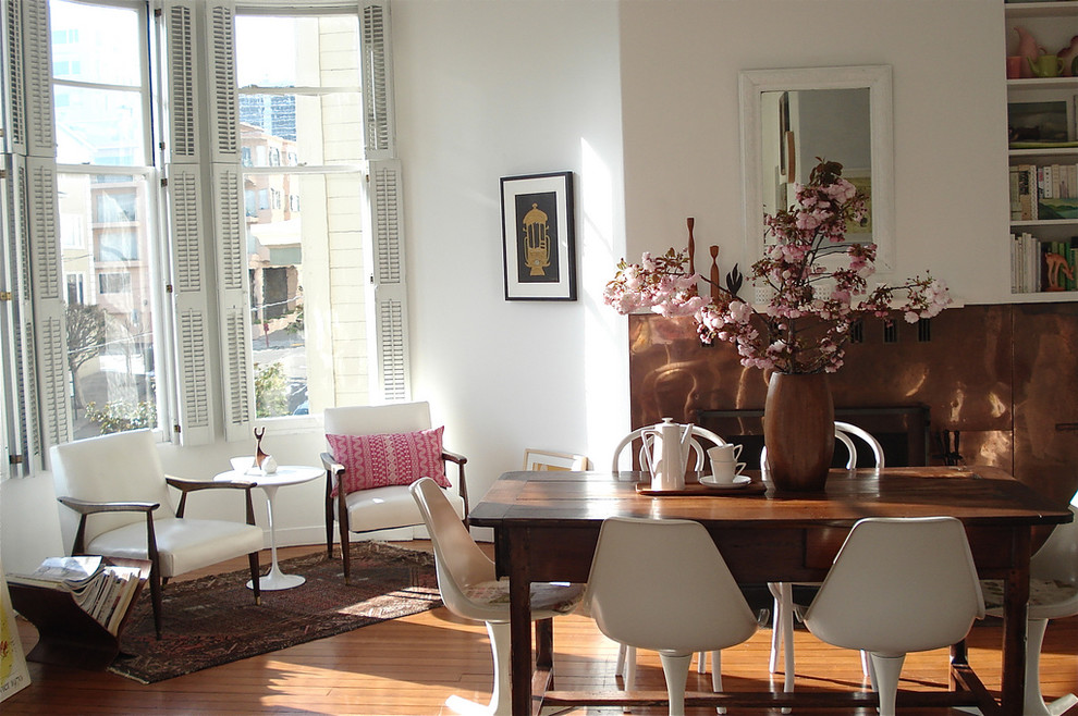 Eclectic dining room in San Francisco with white walls and medium hardwood floors.