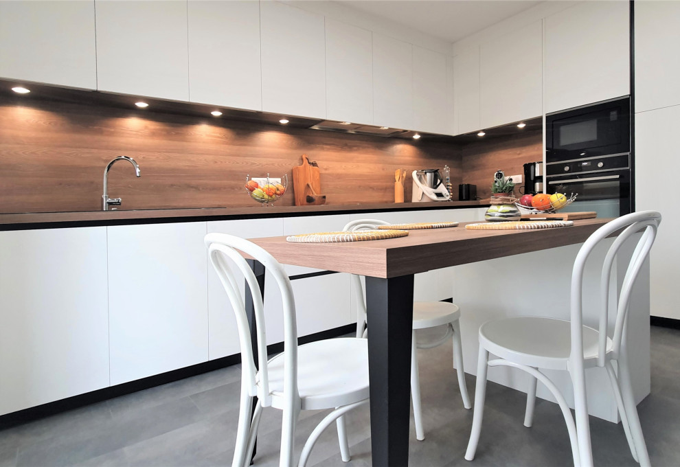 Inspiration for a large contemporary l-shaped open plan kitchen in Other with a submerged sink, flat-panel cabinets, white cabinets, wood worktops, brown splashback, wood splashback, integrated appliances, concrete flooring, an island, grey floors and brown worktops.