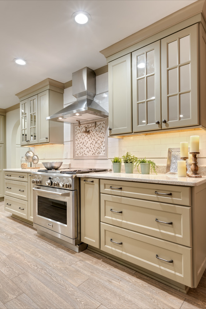 Expansive transitional single-wall eat-in kitchen in Atlanta with a farmhouse sink, recessed-panel cabinets, green cabinets, granite benchtops, white splashback, subway tile splashback, stainless steel appliances, porcelain floors, multiple islands, beige floor and white benchtop.