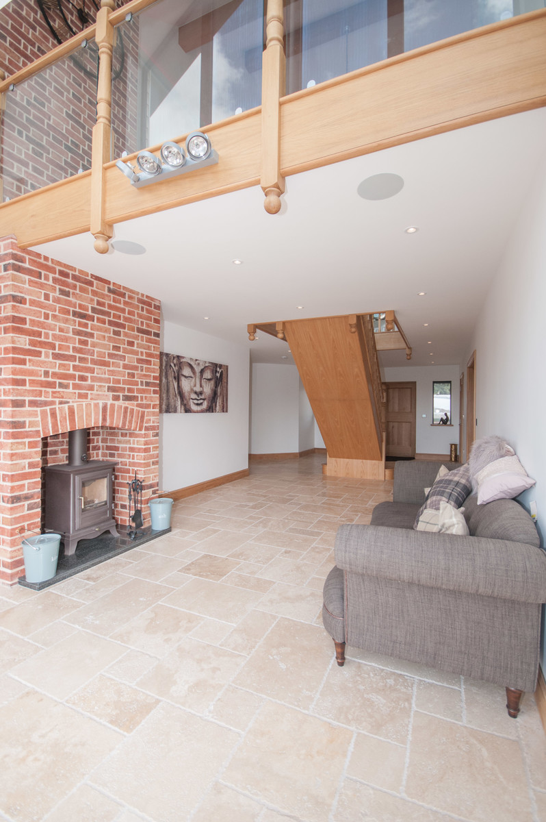 Large transitional living room in Essex with white walls, ceramic floors and brown floor.