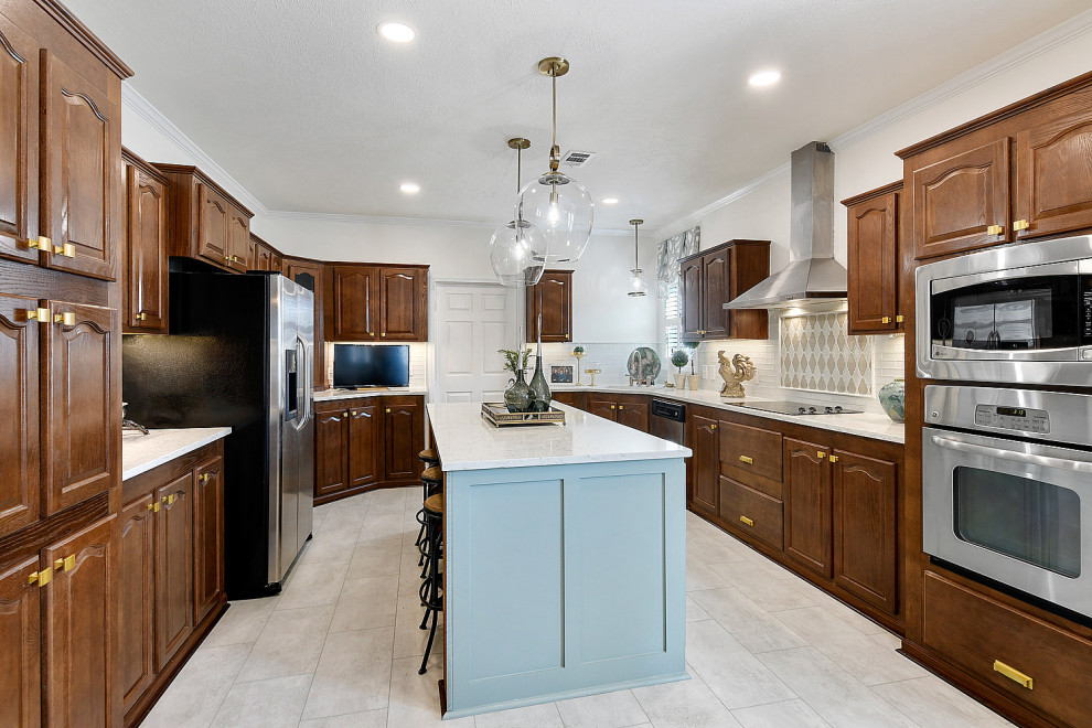 Inspiration for a mid-sized transitional ceramic tile and white floor eat-in kitchen remodel with an undermount sink, raised-panel cabinets, dark wood cabinets, quartz countertops, white backsplash, glass tile backsplash, stainless steel appliances, an island and white countertops
