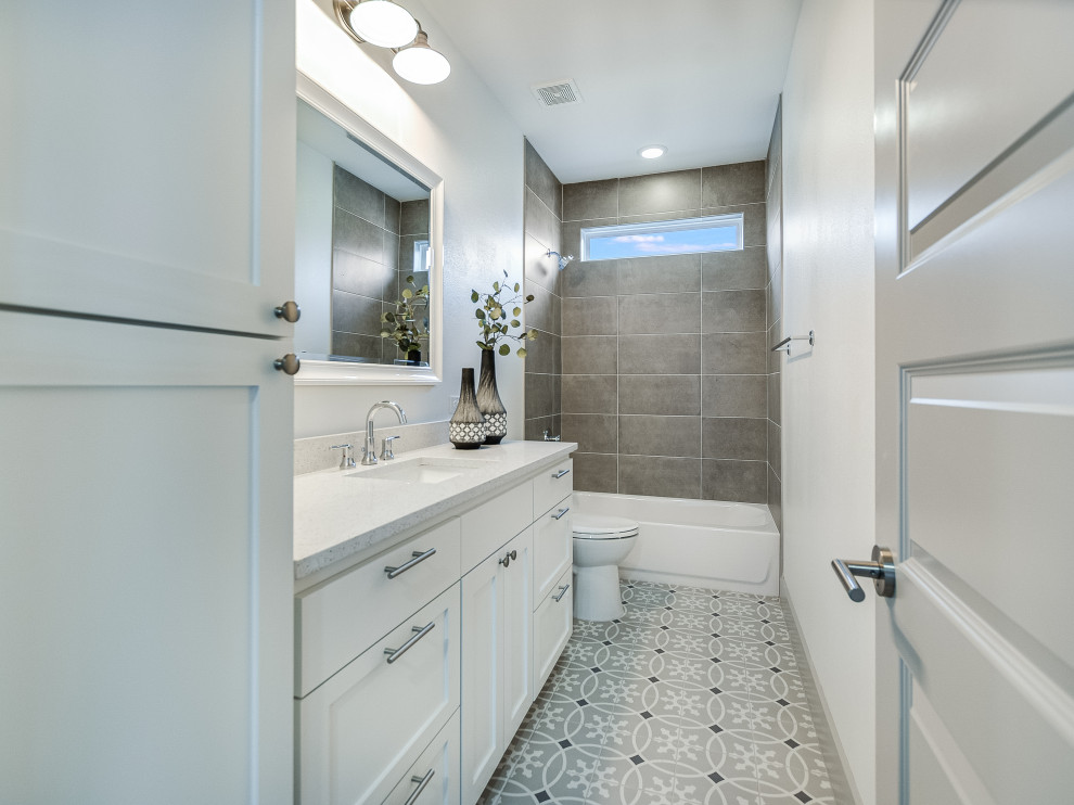 Mid-sized contemporary master bathroom in Austin with shaker cabinets, grey cabinets, a freestanding tub, white walls, ceramic floors, an undermount sink, solid surface benchtops, white floor, white benchtops, a double vanity and a built-in vanity.