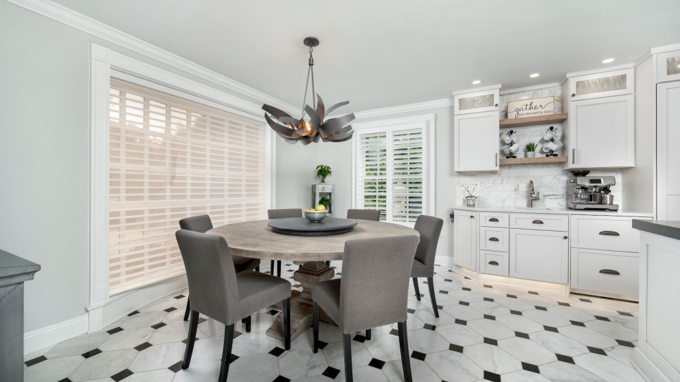 Huge single-wall porcelain tile and white floor eat-in kitchen photo with an undermount sink, shaker cabinets, white cabinets, quartz countertops, white backsplash, ceramic backsplash, stainless steel appliances, two islands and white countertops