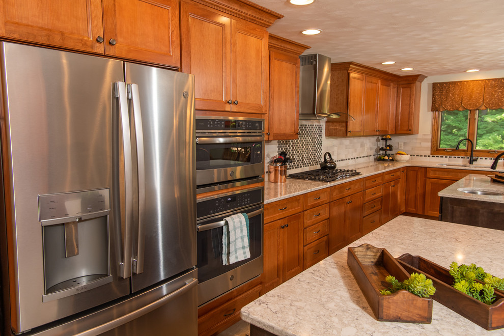 Example of a huge transitional l-shaped porcelain tile and white floor eat-in kitchen design with an undermount sink, flat-panel cabinets, medium tone wood cabinets, quartz countertops, white backsplash, ceramic backsplash, stainless steel appliances, two islands and white countertops