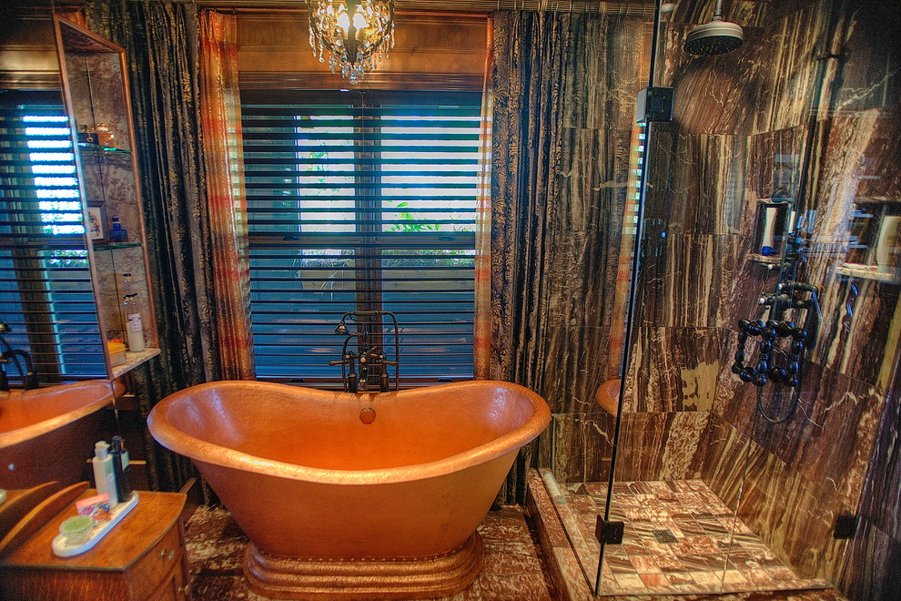 Inspiration for a large eclectic master bathroom in Seattle with an undermount sink, recessed-panel cabinets, dark wood cabinets, marble benchtops, a freestanding tub, a corner shower, a one-piece toilet, multi-coloured tile, stone tile, marble floors and brown walls.
