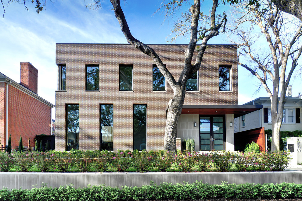 This is an example of a mid-sized contemporary two-storey brick exterior in Houston.