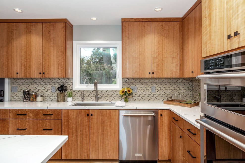 Inspiration for a mid-sized midcentury l-shaped separate kitchen in Portland with an undermount sink, flat-panel cabinets, medium wood cabinets, quartz benchtops, green splashback, mosaic tile splashback, stainless steel appliances, medium hardwood floors, with island, brown floor and white benchtop.