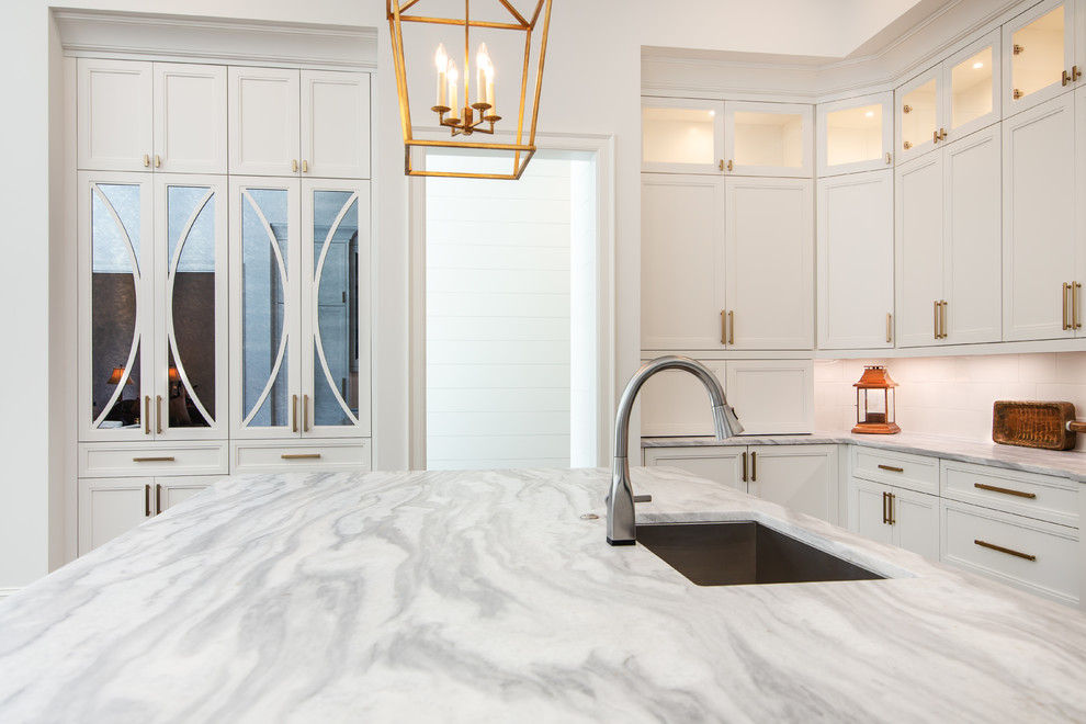 Inspiration for a large transitional u-shaped open plan kitchen in Charlotte with a double-bowl sink, beaded inset cabinets, white cabinets, quartzite benchtops, white splashback, ceramic splashback, panelled appliances, dark hardwood floors, with island and white benchtop.