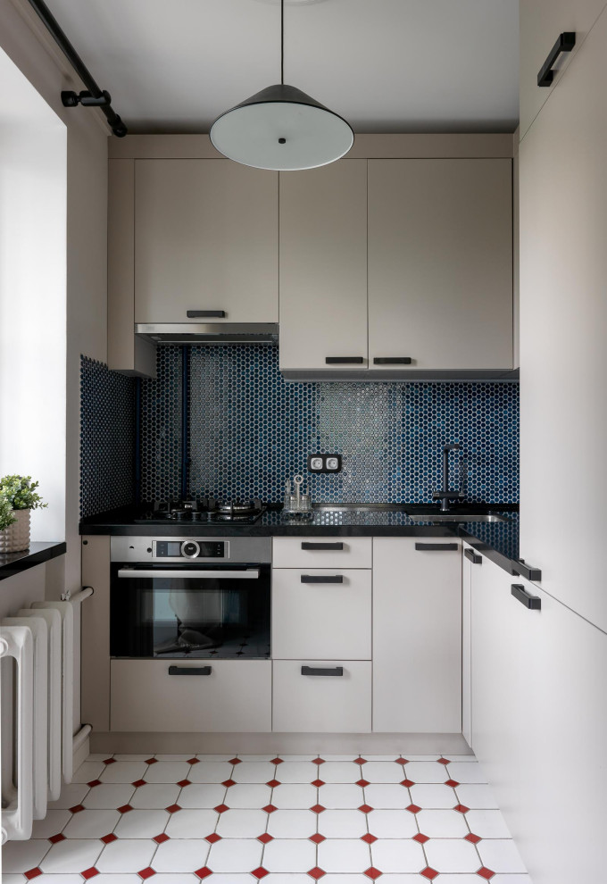 Small l-shaped kitchen in Moscow with an undermount sink, flat-panel cabinets, beige cabinets, quartz benchtops, blue splashback, mosaic tile splashback, stainless steel appliances, ceramic floors, no island, white floor and black benchtop.