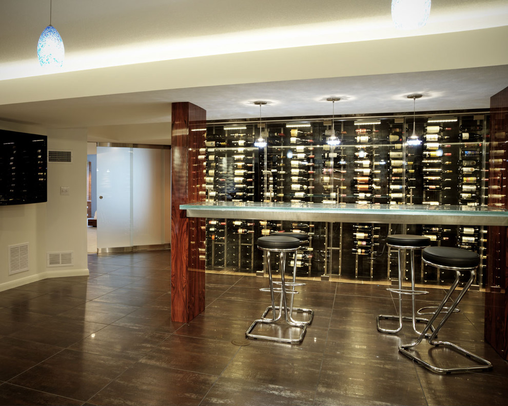 Photo of a large contemporary wine cellar in Wichita with vinyl floors, display racks and black floor.