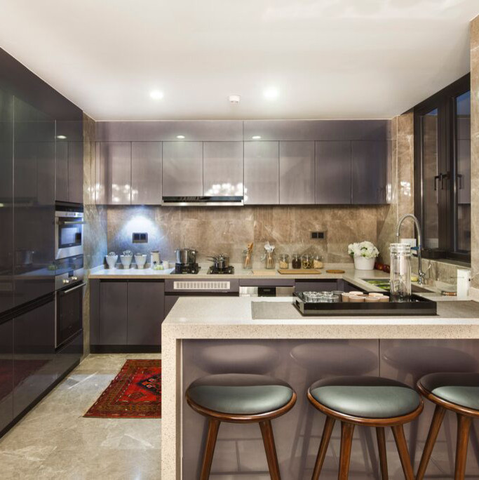 Photo of a small contemporary l-shaped eat-in kitchen in New York with an undermount sink, flat-panel cabinets, purple cabinets, quartzite benchtops, beige splashback, stone tile splashback, stainless steel appliances, porcelain floors and a peninsula.